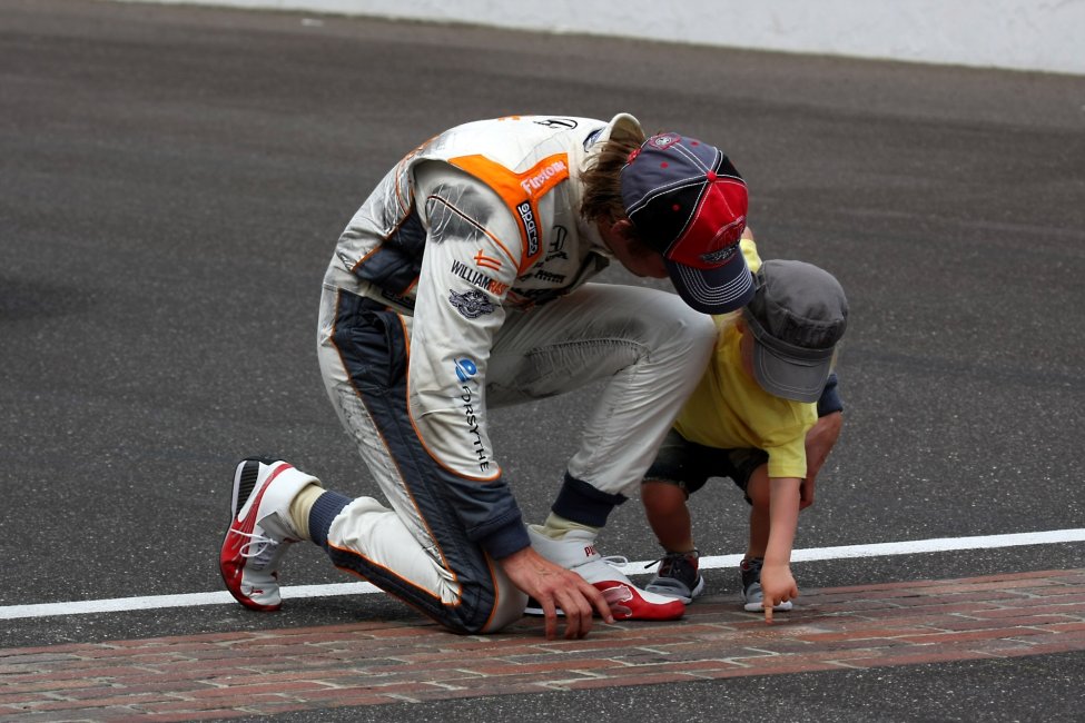 Dan Wheldon looking at the bricks of the Indianapolis Motor Speedway prior to the Indy 500.